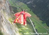 BASE jumper exit from cliff down the valley