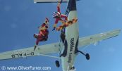 Skysurfer exiting the aircraft next to freeflyer