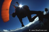 skateboard skydive jump under canopy in the blue sky