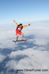 skateboard skydive jump in the blue sky